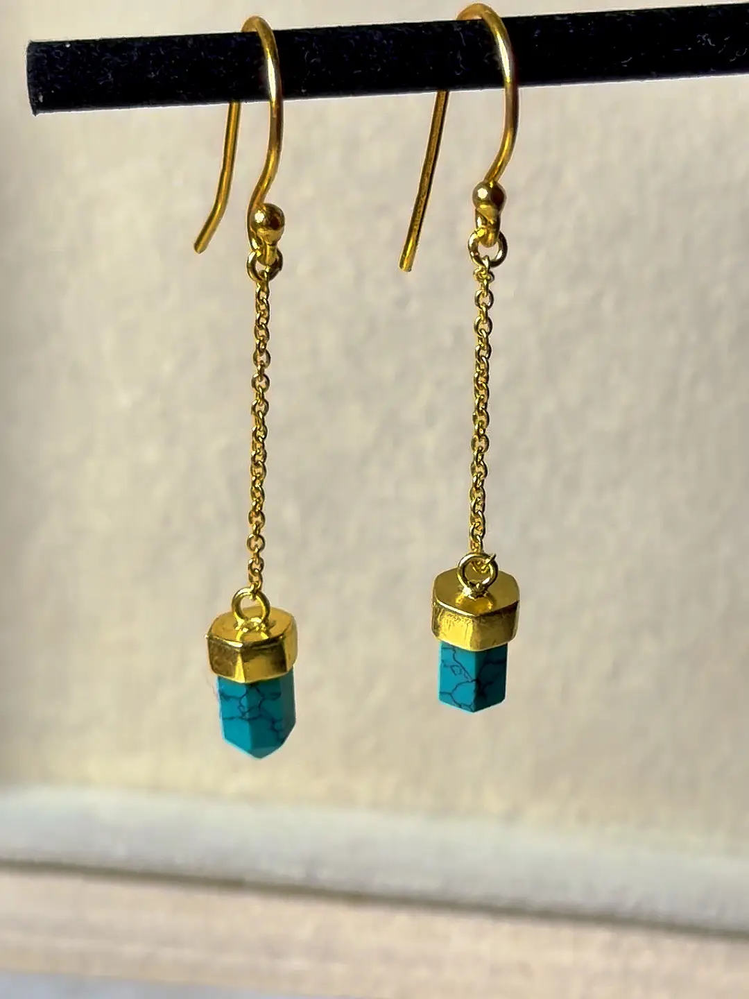 Boond gold-plated silver earrings with faceted turquoise points hanging from fine gold chains
