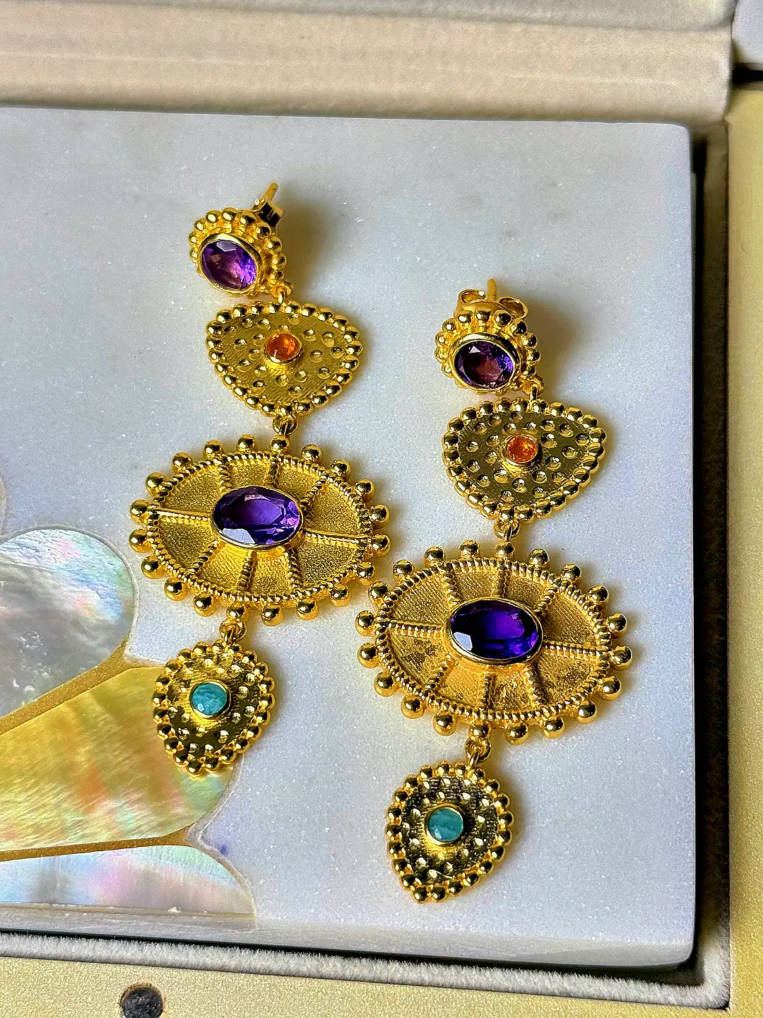 Surya gold-plated silver temple drop earrings with granulated tiers, amethyst sunburst medallions, carnelian and turquoise